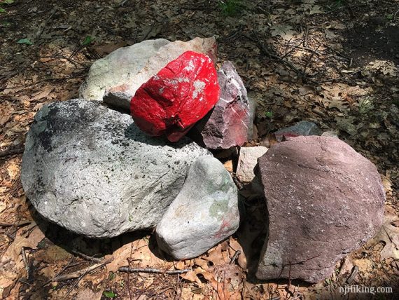 Painted red rock on cairn