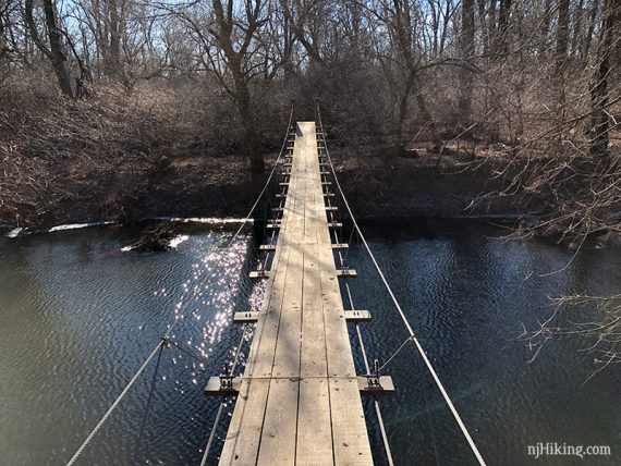 Swinging bridge over a stream.