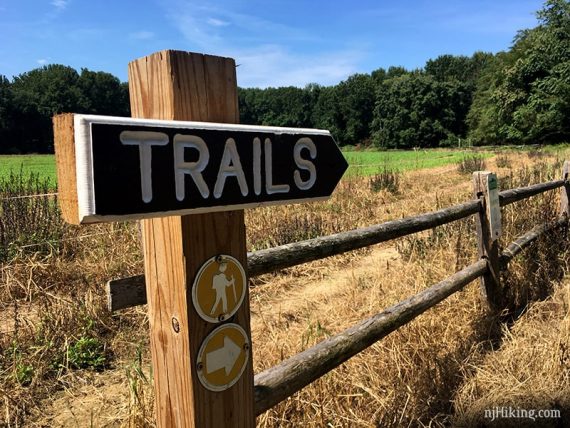 Arrow trail sign on a fence