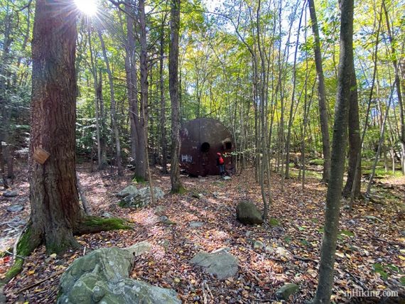 Water tank with a hiker next to it for size.