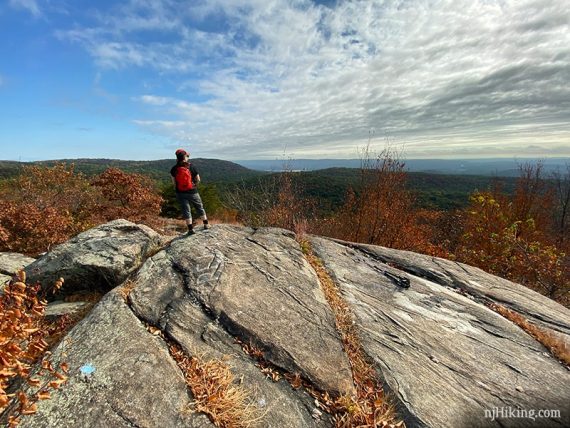 Hiker looking at the view from a large rock outcrop called Osio Rock.