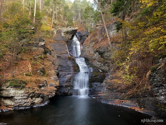 Raymondskill Falls with fall foliage on either side.