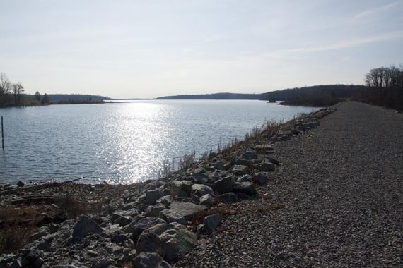 Trail crosses the dike on crushed stone.