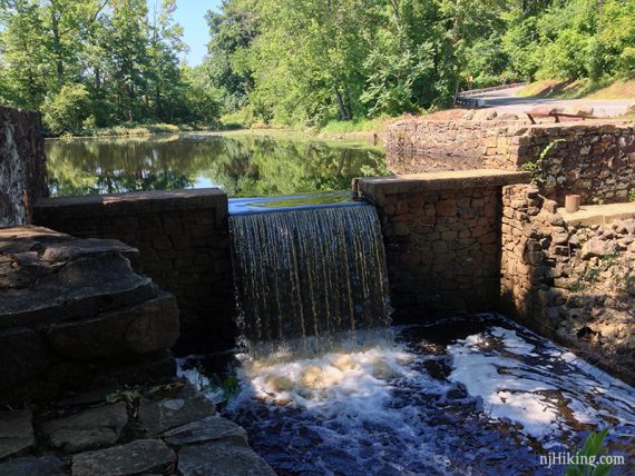 Stone wall with water cascading through the middle.