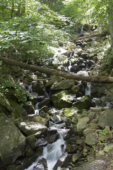 Tall waterfall tumbling over rocks.