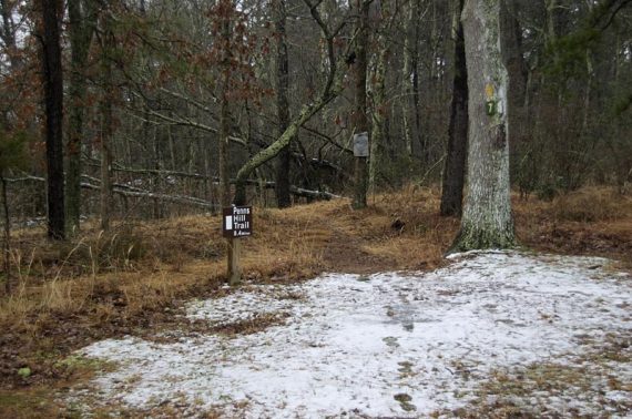 Penns Hill Trail sign next to a snowy trail.