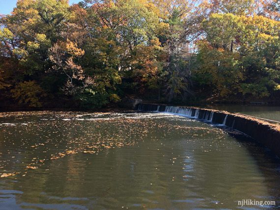 Curved stone dam on Westons Pond.