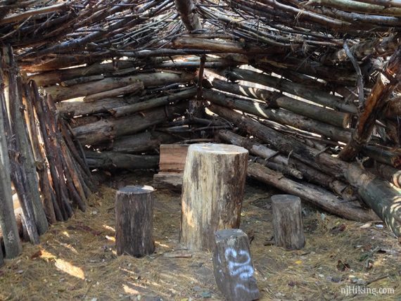 Shelters made from stacking branches and logs.