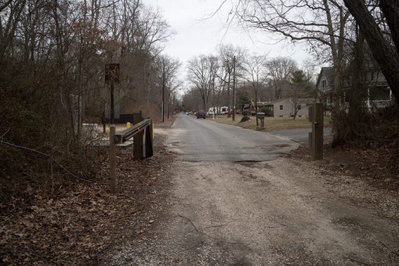 Woods road ends at a street.