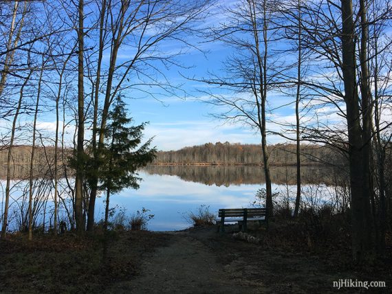 View of McCormack Lake with a bench next to a side trail.