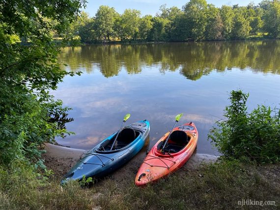 Two kayaks at the edge of the lake