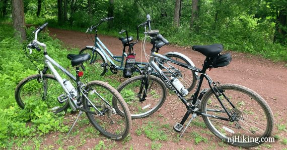 Multiple bikes on a dirt rail trail bike path.