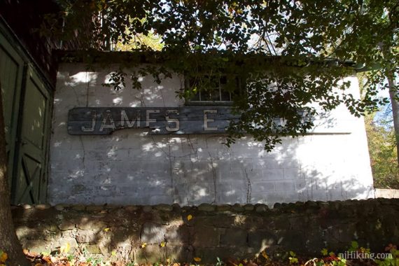 White building with James E visible on the sign.