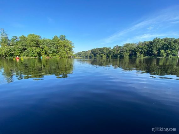 Bright blue lake with green trees around it.