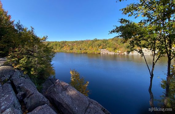 Bright blue Terrace Pond seen from a rocky outcrop.