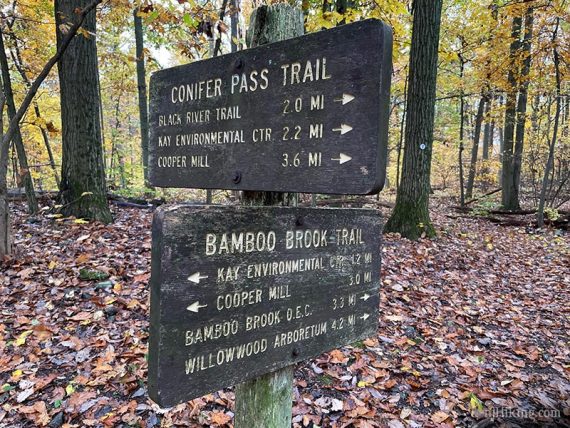 Large wooden signs for Conifer Pass and Bamboo Brook trails.