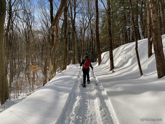 Snowshoeing in wide snowy tracks