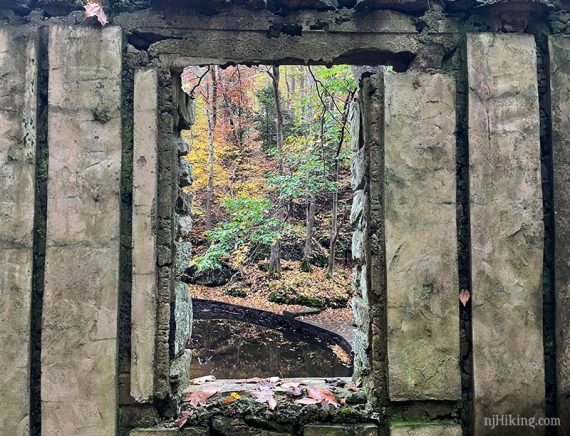 Looking through a window in a stone wall.