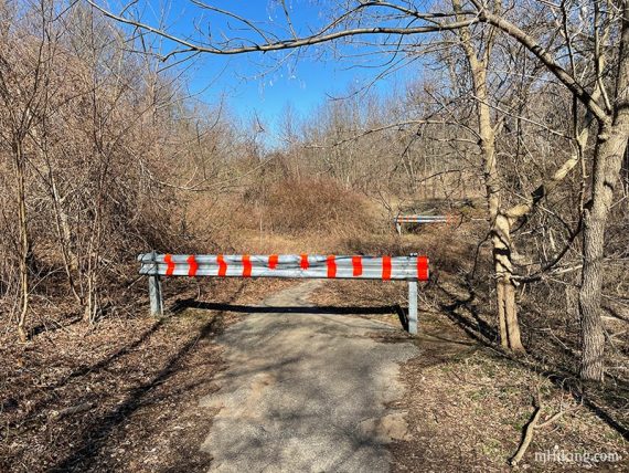 Metal barricade across a trail