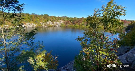 Bright blue Terrace pond surrounded by rocks and trees