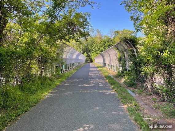 Approaching a bridge with a talll curved fence on either side