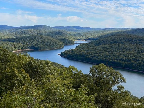 Green hills surrounding a curved reservoir