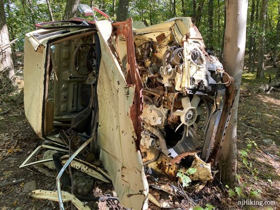 Old vehicle left on the side of a trail