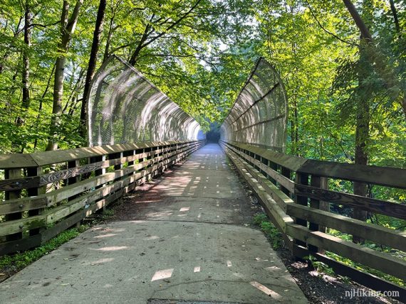 Trestle bridge with curved fenced sides.