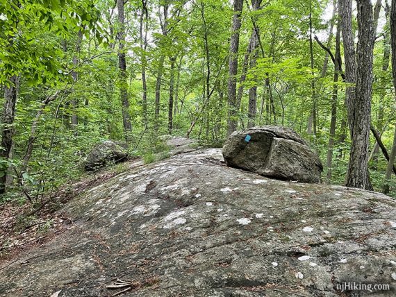 Large slab of rock with a boulder on it