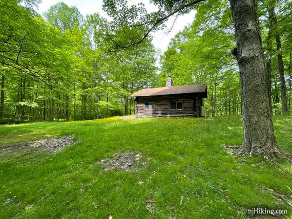 Stokes cabin in an open grassy area