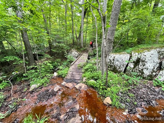 Hiker across a footbridge