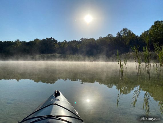 Kayaks in fog on a lake