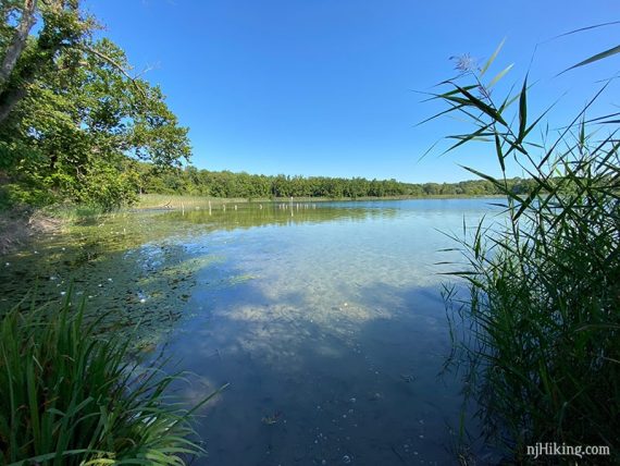 White lake with old dock posts seen in the distance.