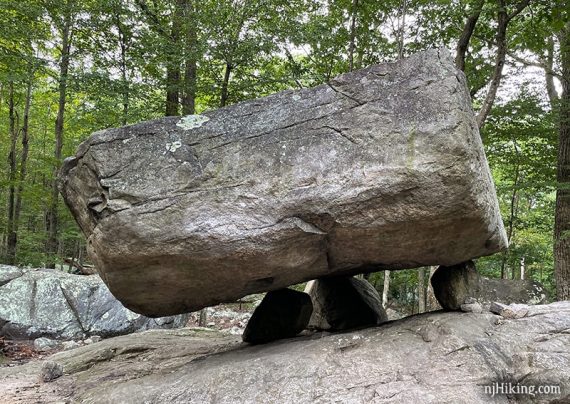 Large boulder balanced on three smaller rocks