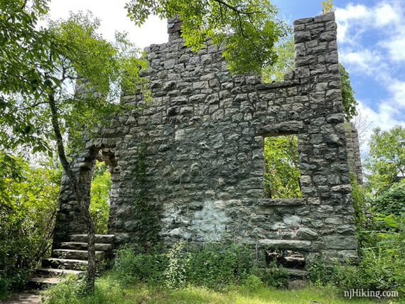 Large intact stone wall with arched doorway and steps