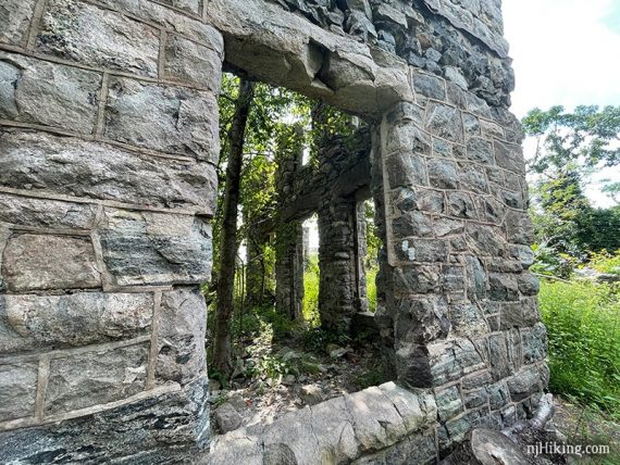 Corner of stone castle with white trail marker