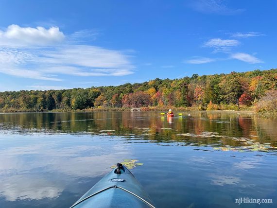 Kayaker on a lake with fall foliage