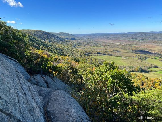 Foliage covered hills seen from a rocky outcrop