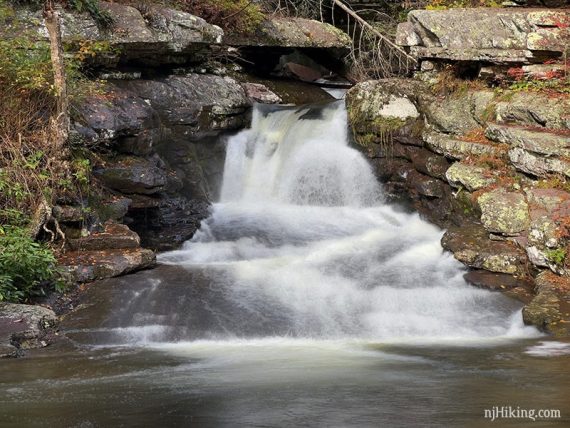 Close up of water flowing over a break in rocks.