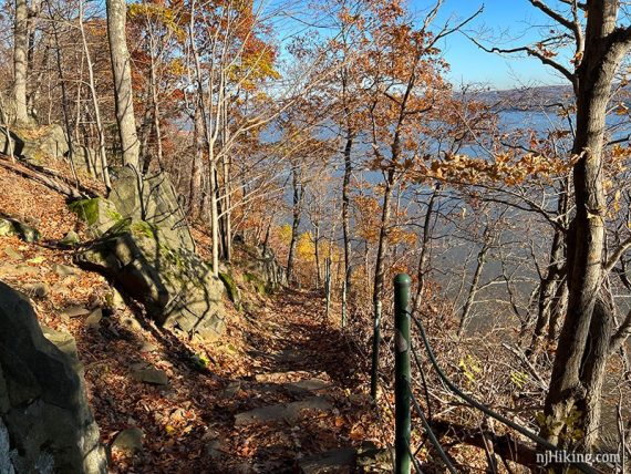 Trail along the edge of a cliff with a cable railing.