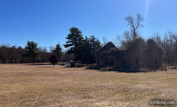 Stone building remains across a field.