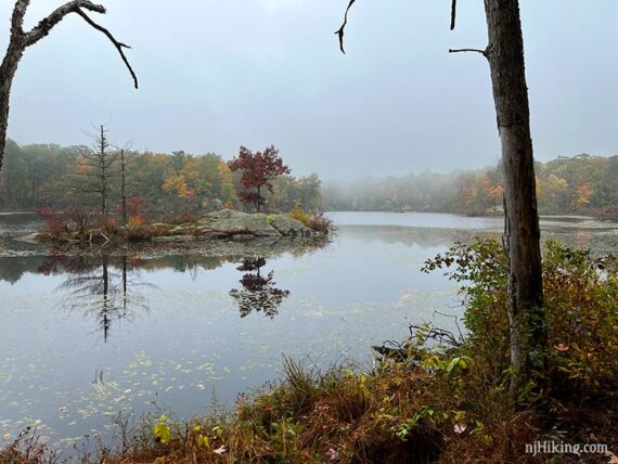 Rocky island on a foggy lake