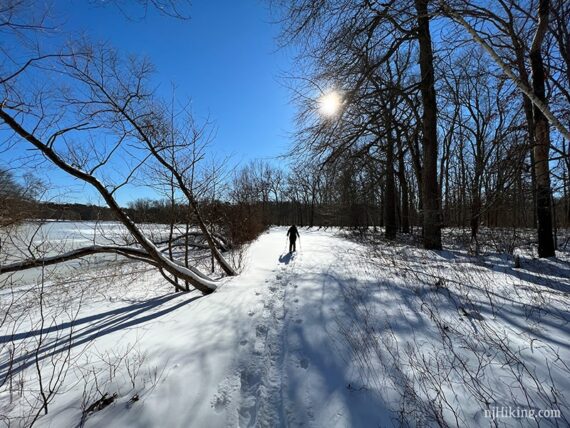 Snowshoeing a trail near a frozen lake