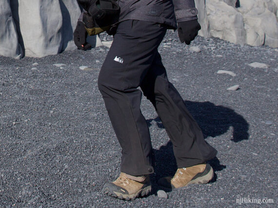 Wind and rain pants on a hiker.