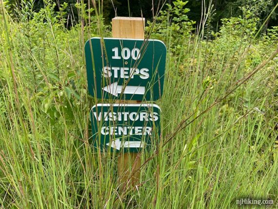 Wooden trail post with a sign for 100 Steps.
