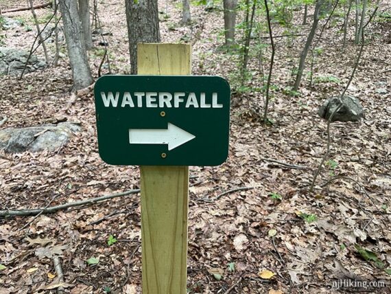 Wooden post with a waterfall sign.