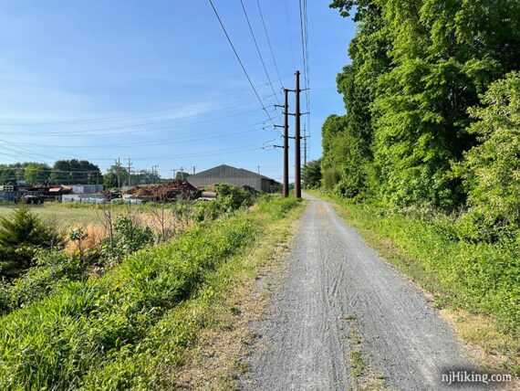 Rail trail next to farm buildings.