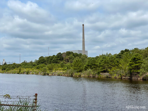 Power station building and stack with Oyster Creek in the foreground