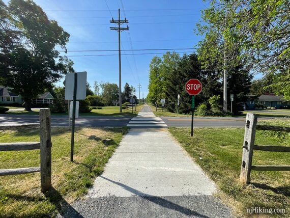Rail trail approaching a street crossing.