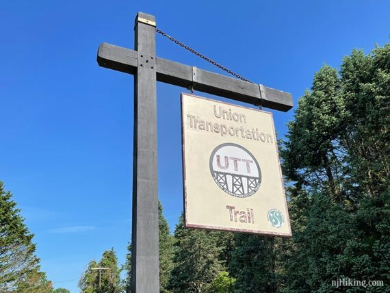 Union Transportation Trail sign hanging from a wooden post.
